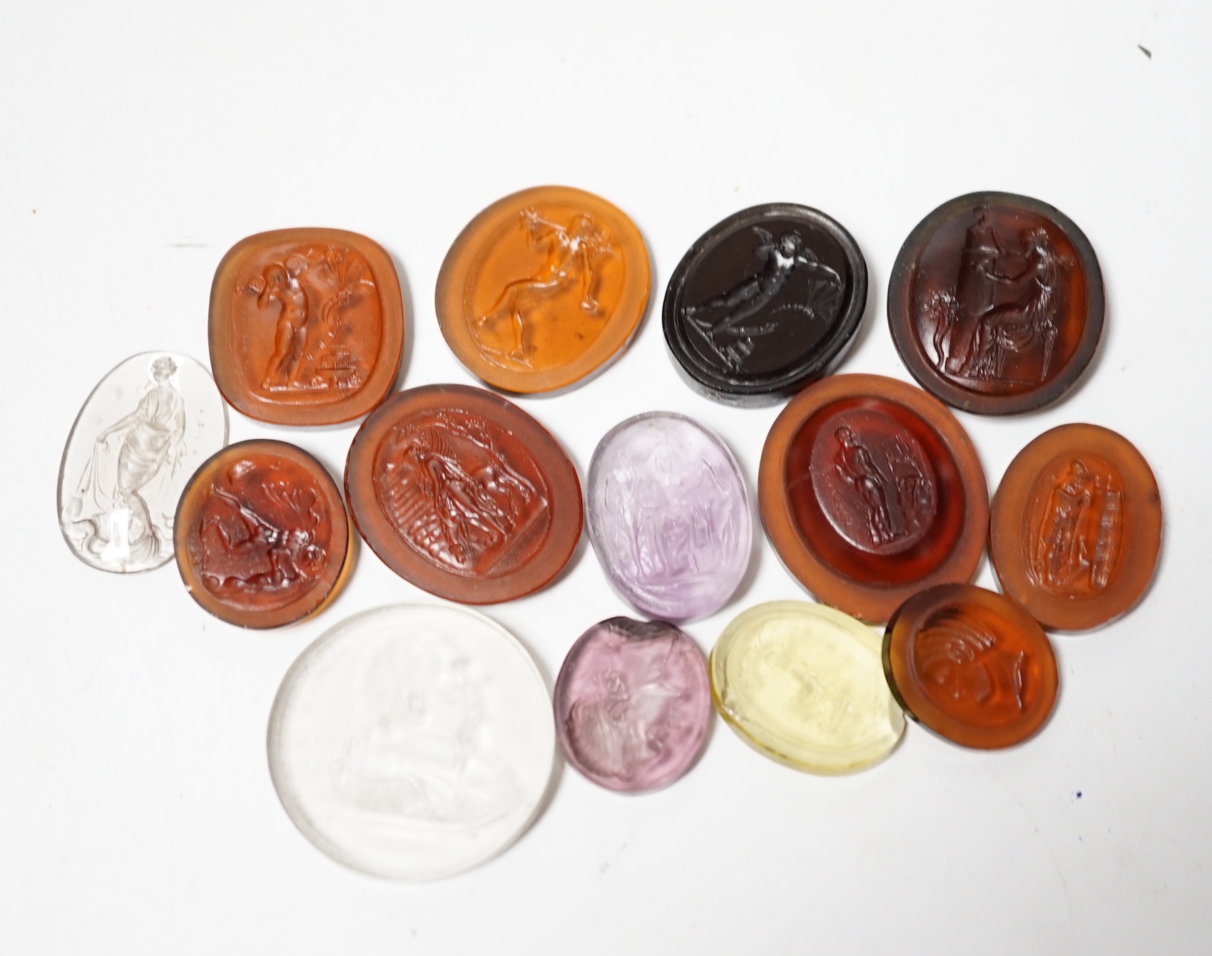 Fourteen 19th century intaglio glass matrices, largest approx. 3cm diameter